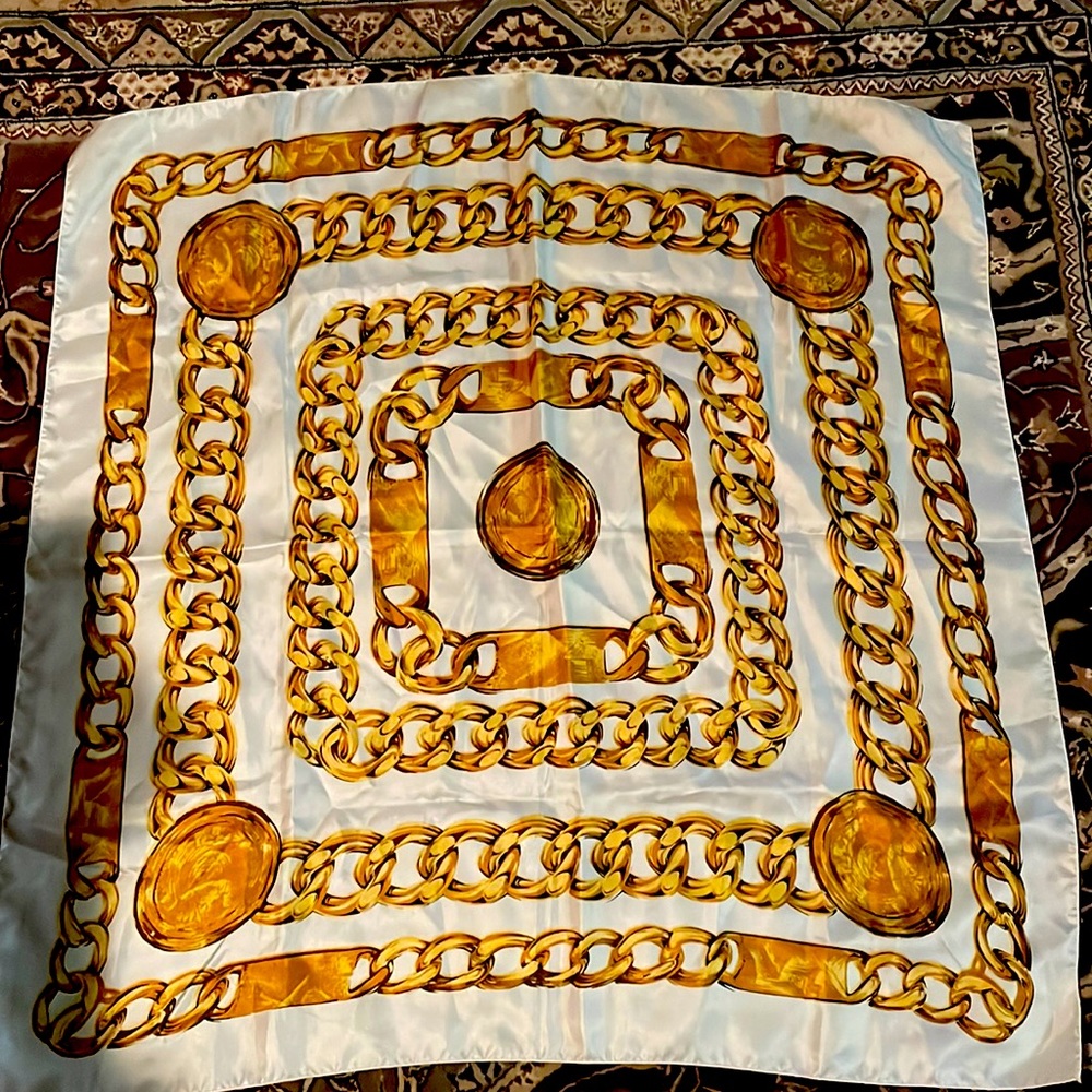 Scarf. 34” x 34”. 100% polyester. Gold link pattern.